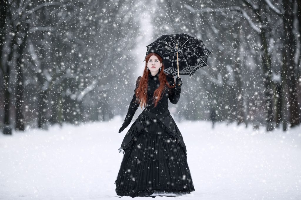 woman dressed in victorian fashion in the snow
